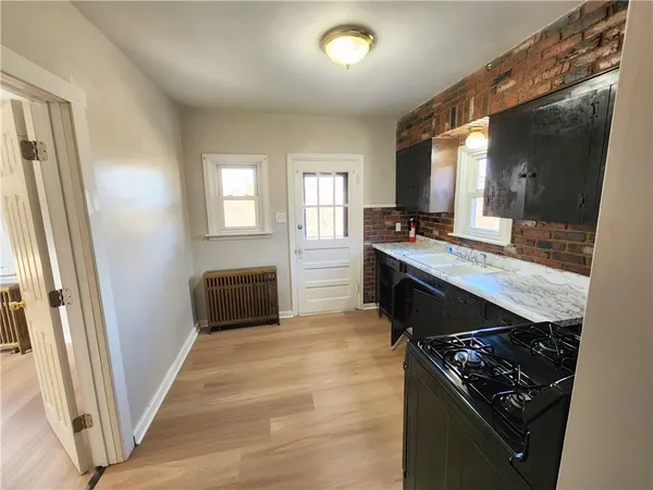 a kitchen with granite countertop a stove and a sink