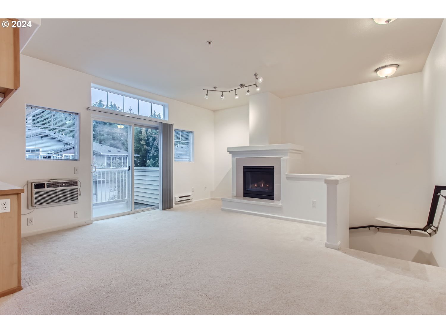 14740 Southwest Sandhill Loop, Unit 203 Beaverton, OR 97007 - Photo 12 of 35 a view of an empty room with a fireplace and a window