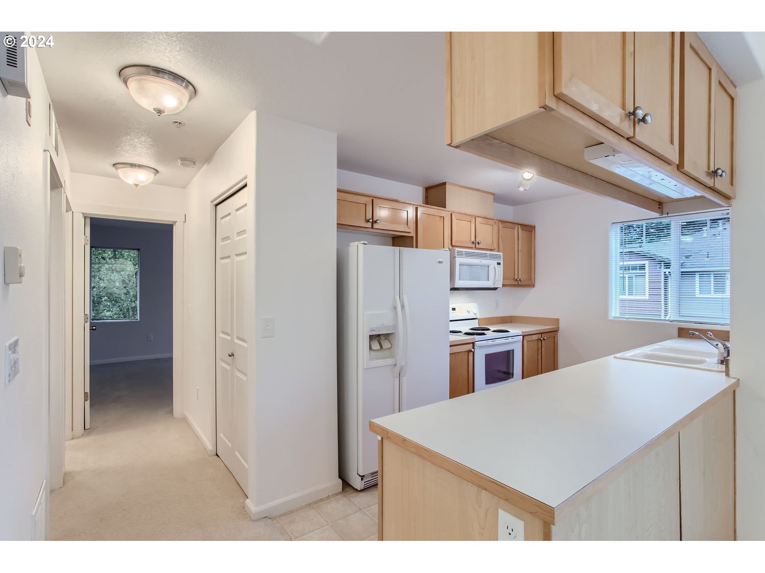 14740 Southwest Sandhill Loop, Unit 203 Beaverton, OR 97007 - Photo 13 of 35 a kitchen view with stainless steel appliances cabinets and a counter top space