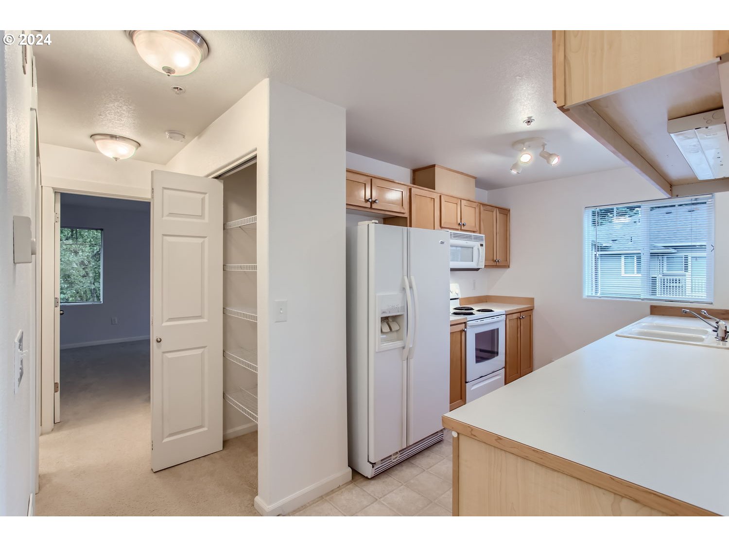 14740 Southwest Sandhill Loop, Unit 203 Beaverton, OR 97007 - Photo 14 of 35 a kitchen with stainless steel appliances a refrigerator and a stove