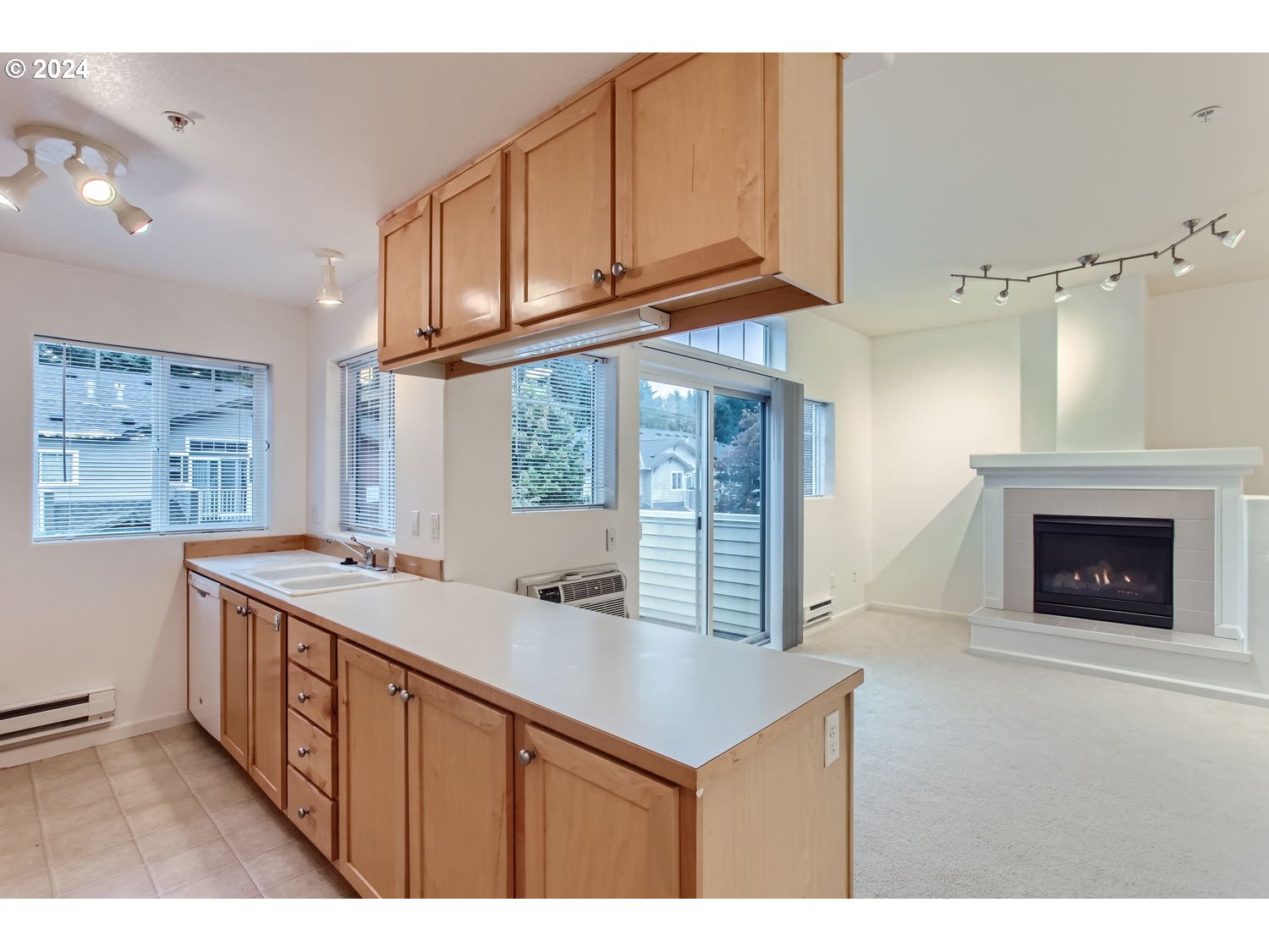 14740 Southwest Sandhill Loop, Unit 203 Beaverton, OR 97007 - Photo 15 of 35 a kitchen with stainless steel appliances granite countertop a stove a sink and a microwave