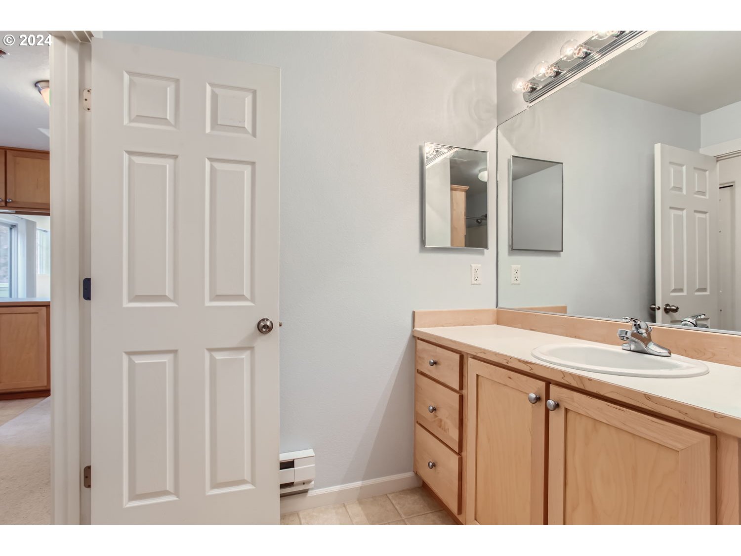 14740 Southwest Sandhill Loop, Unit 203 Beaverton, OR 97007 - Photo 28 of 35 a bathroom with a sink vanity and mirror