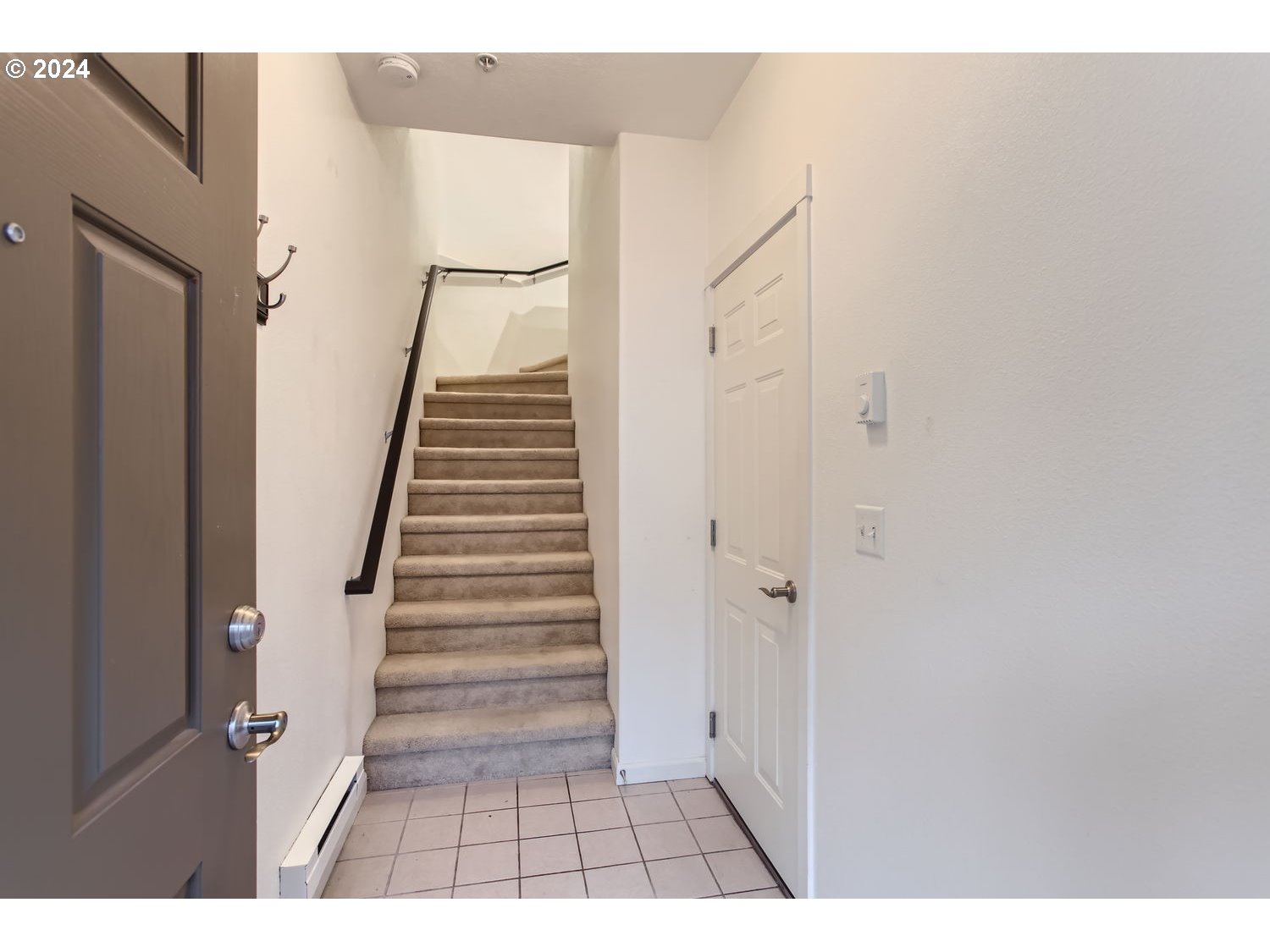 14740 Southwest Sandhill Loop, Unit 203 Beaverton, OR 97007 - Photo 31 of 35 a view of a hallway with white walls and railing