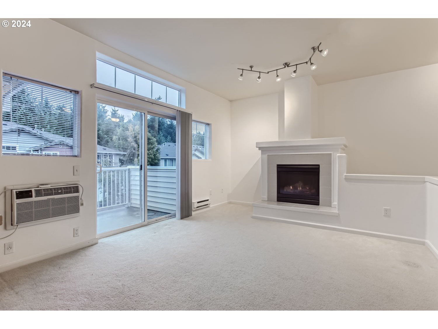 14740 Southwest Sandhill Loop, Unit 203 Beaverton, OR 97007 - Photo 5 of 35 a view of an empty room with a fireplace and a window