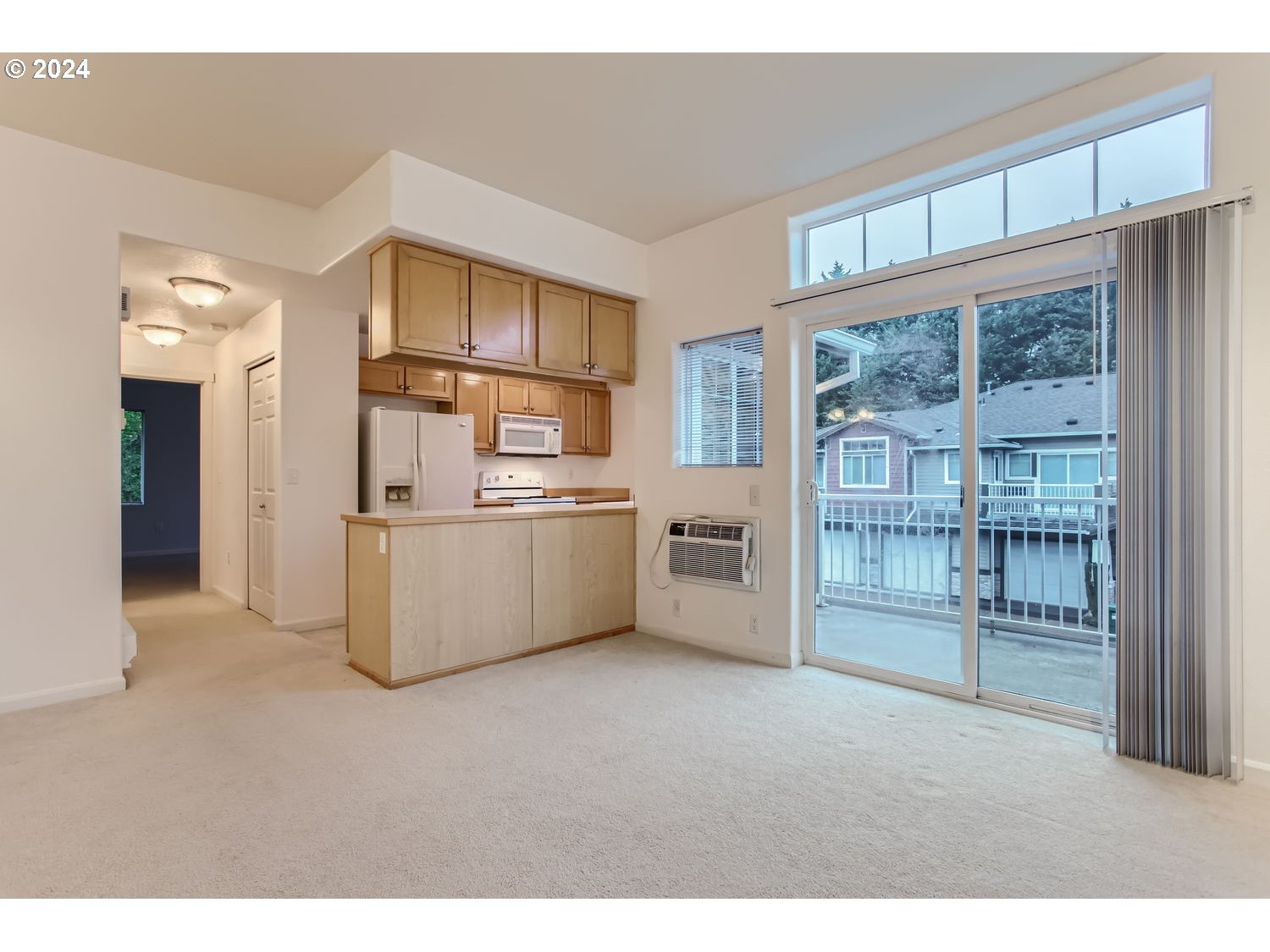 14740 Southwest Sandhill Loop, Unit 203 Beaverton, OR 97007 - Photo 8 of 35 a kitchen with white cabinets and white appliances