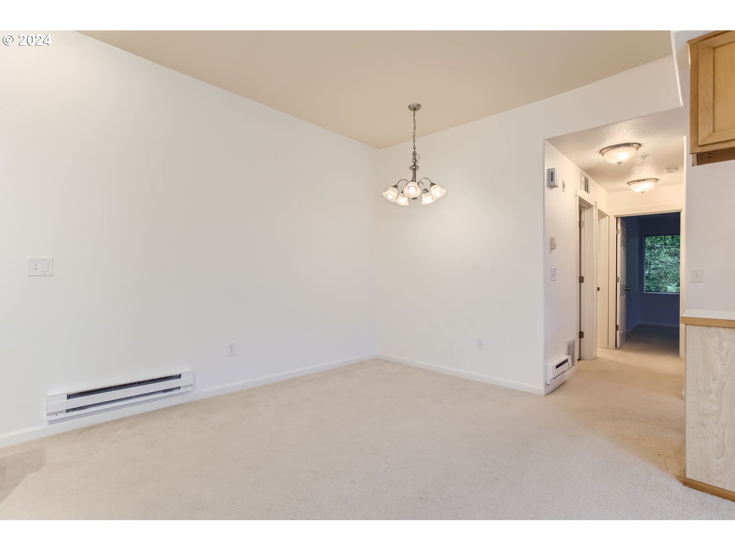 14740 Southwest Sandhill Loop, Unit 203 Beaverton, OR 97007 - Photo 10 of 35 a view of a room with closet and a chandelier fan