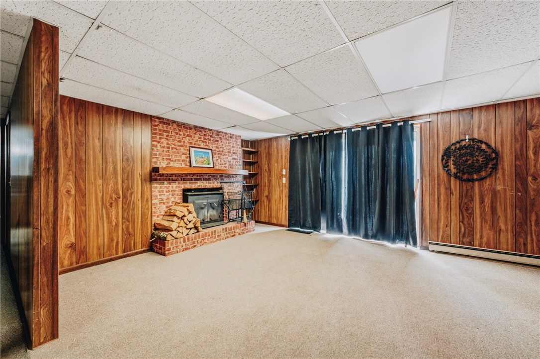 707 Campbell Town Road Walhalla, SC 29691 - Photo 25 of 44 Rich wood paneling and a classic brick fireplace anchor this versatile finished basement space.