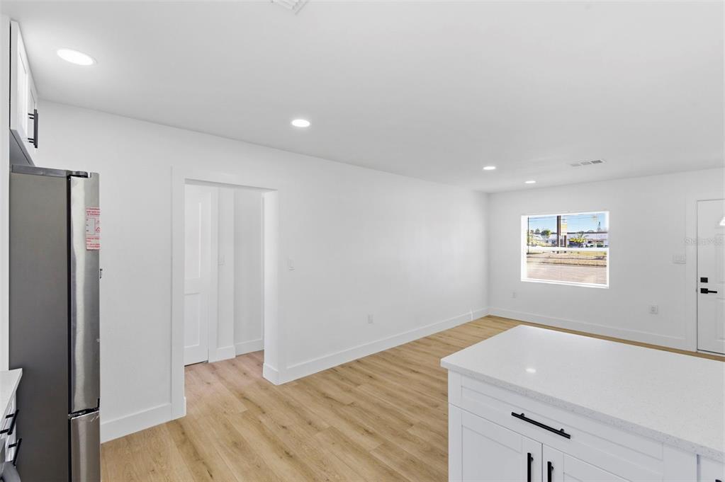 1448 South Belcher Road Largo, FL 33771 - Photo 16 of 47 a view of a kitchen with wooden floor and a ceiling fan