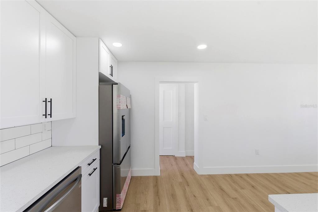 1448 South Belcher Road Largo, FL 33771 - Photo 17 of 47 a view of a refrigerator in kitchen and wooden floor