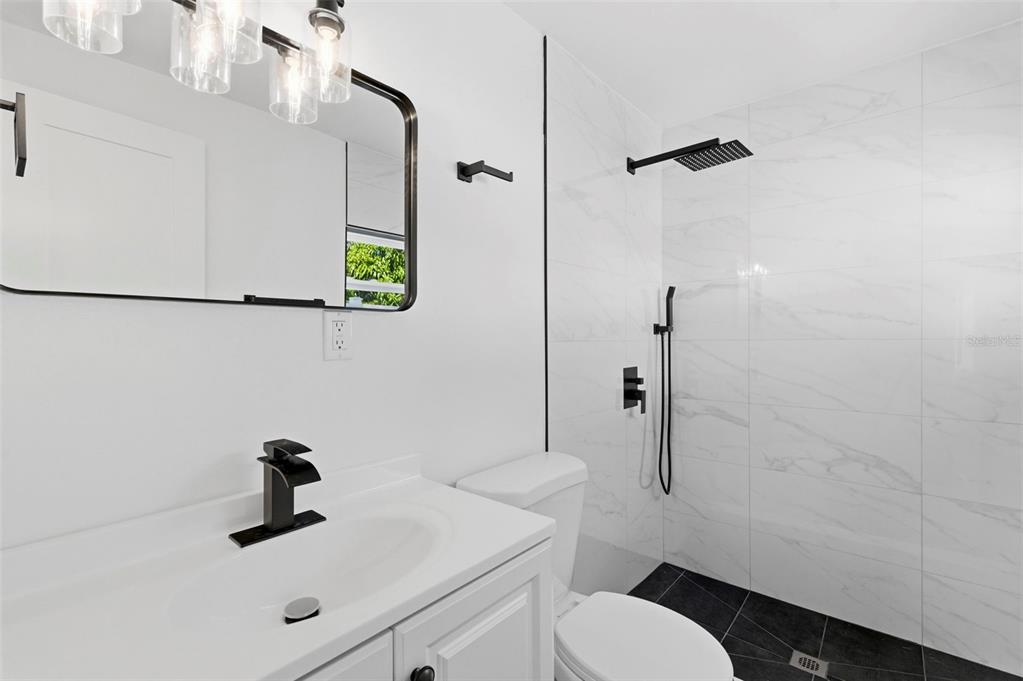 1448 South Belcher Road Largo, FL 33771 - Photo 23 of 47 a bathroom with a sink toilet and shower