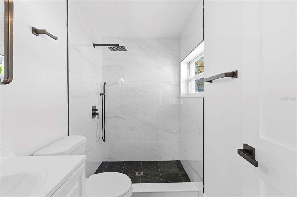 1448 South Belcher Road Largo, FL 33771 - Photo 24 of 47 a bathroom with a toilet and a shower