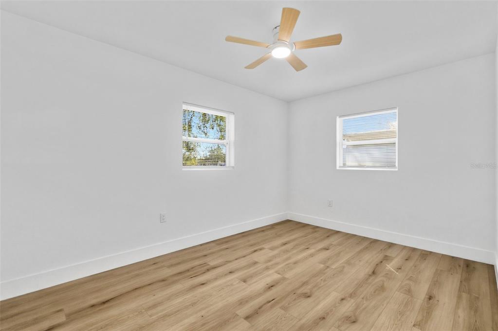 1448 South Belcher Road Largo, FL 33771 - Photo 25 of 47 a view of empty room with wooden floor and fan