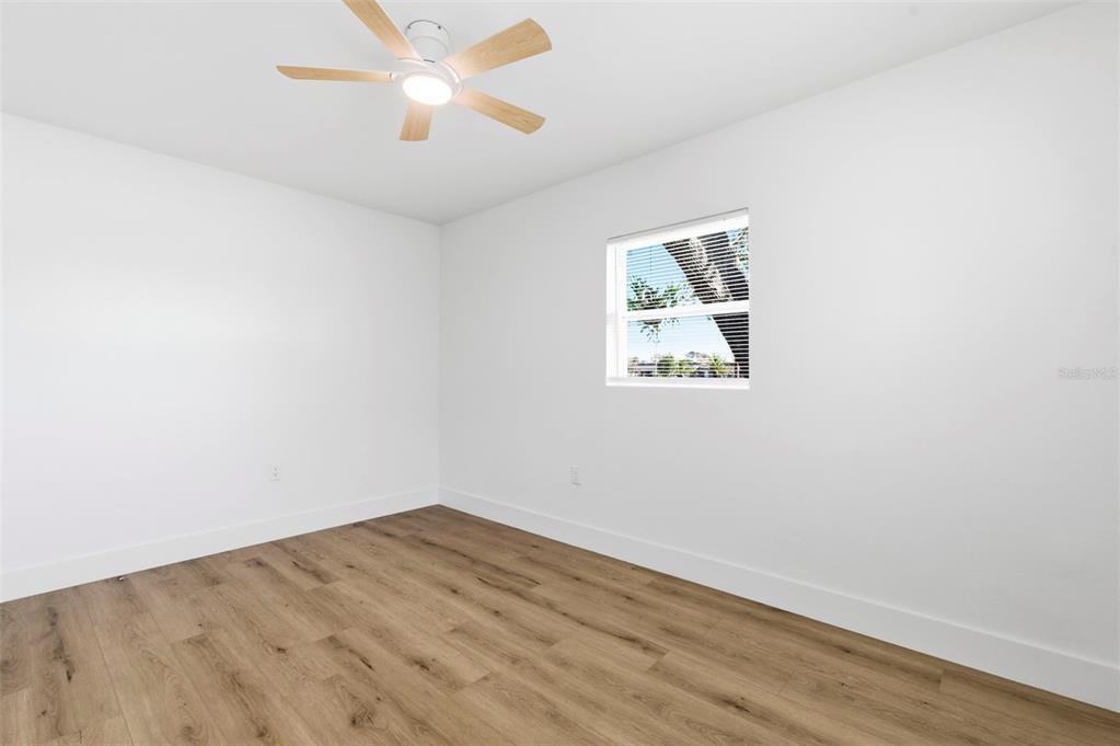 1448 South Belcher Road Largo, FL 33771 - Photo 27 of 47 an empty room with a window and wooden floor