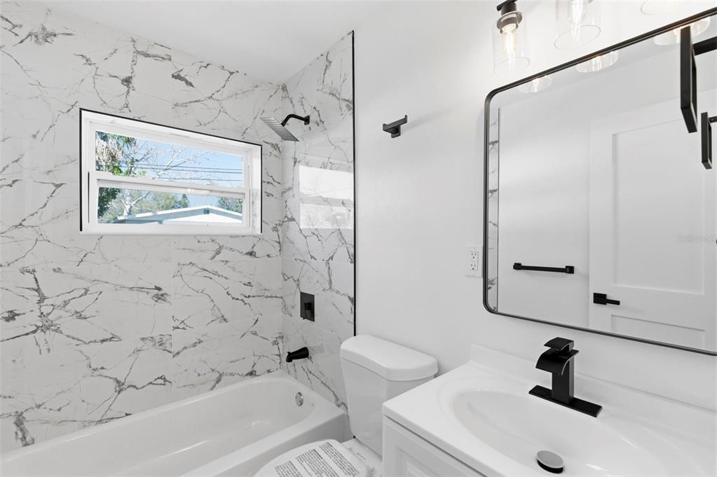 1448 South Belcher Road Largo, FL 33771 - Photo 32 of 47 a bathroom with a sink and a bathtub