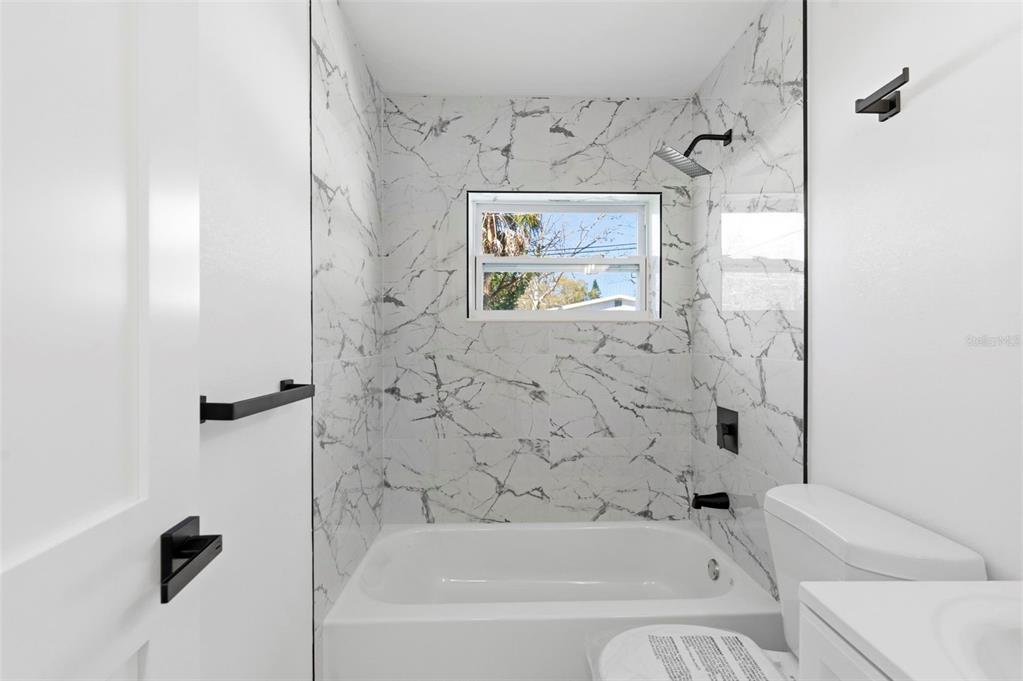 1448 South Belcher Road Largo, FL 33771 - Photo 33 of 47 a bathroom with a bathtub and a shower