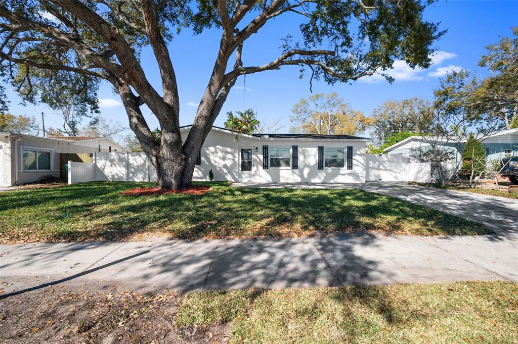 1448 South Belcher Road Largo, FL 33771 - Photo 4 of 47 a front view of a house with a yard