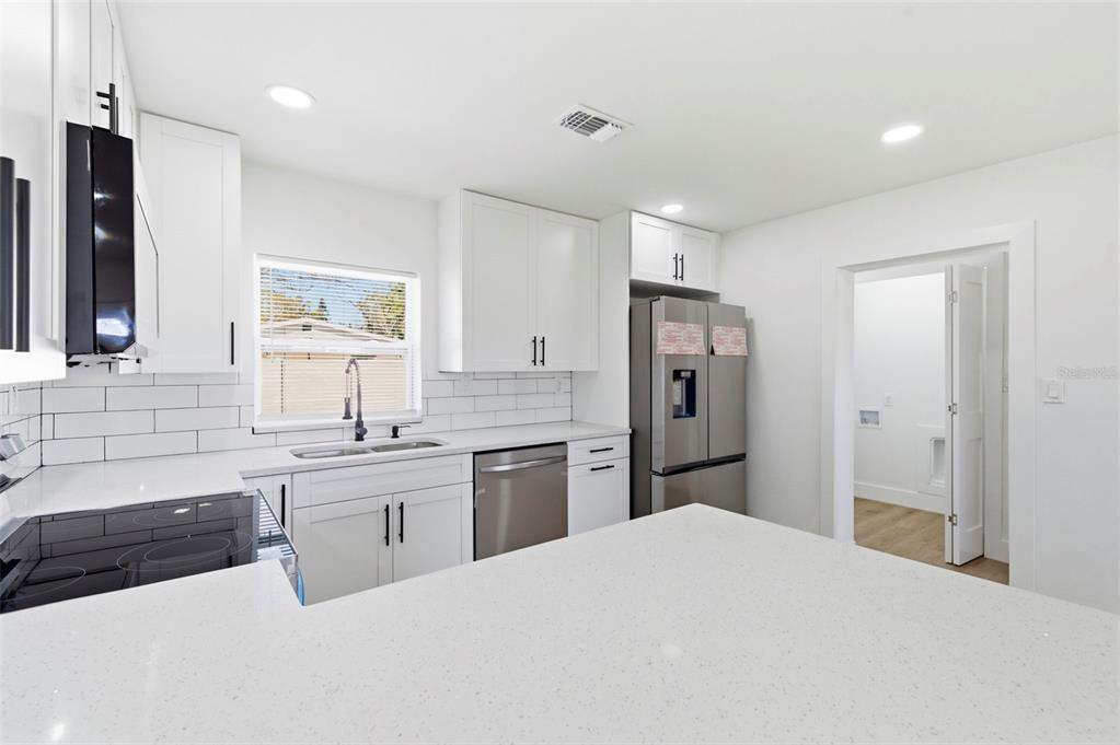 1448 South Belcher Road Largo, FL 33771 - Photo 10 of 47 a kitchen with a refrigerator a sink and dishwasher