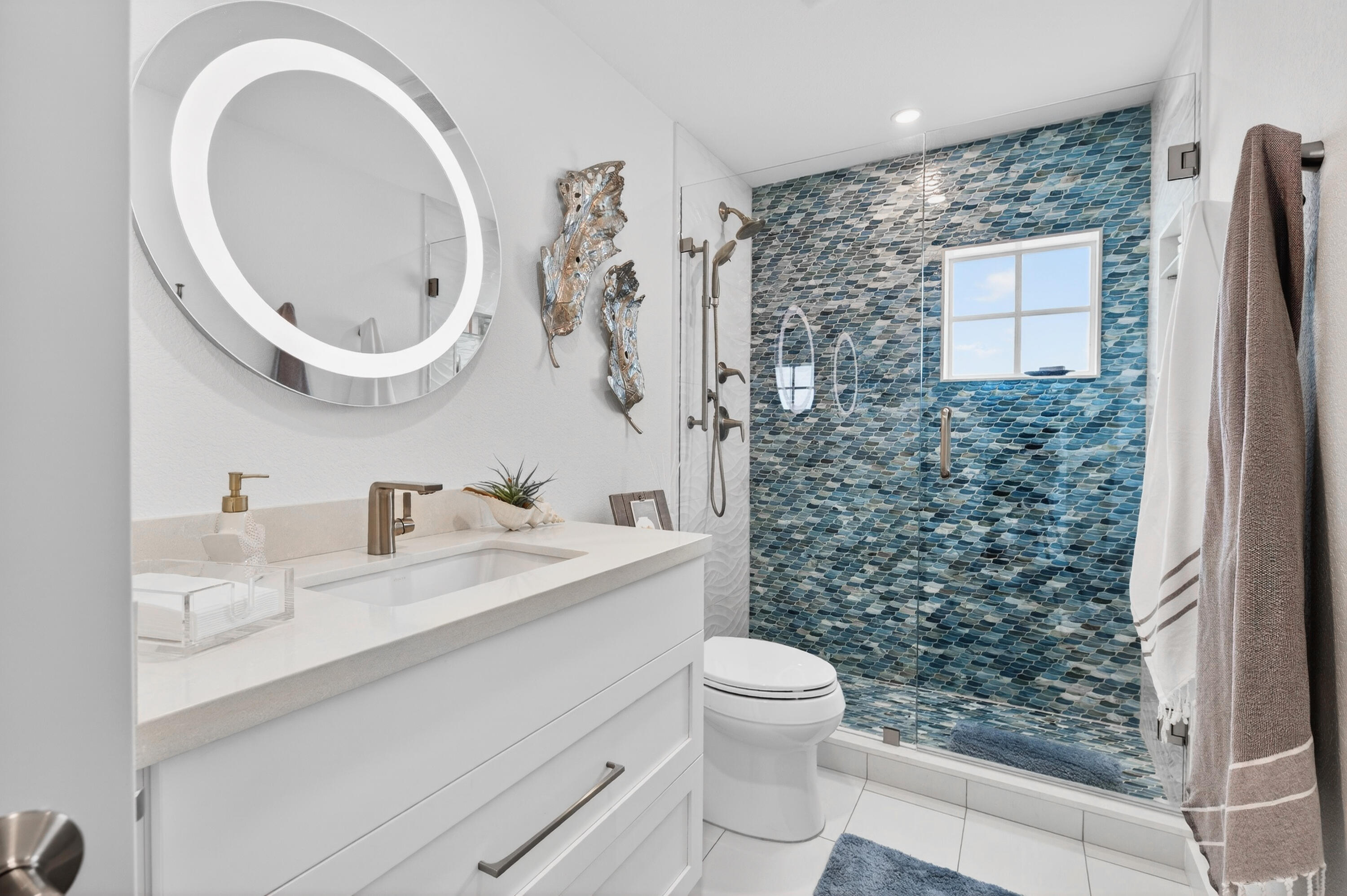 5605 College Road, Unit E305 Key West, FL 33040 - Photo 12 of 40 a bathroom with a sink a toilet and a shower