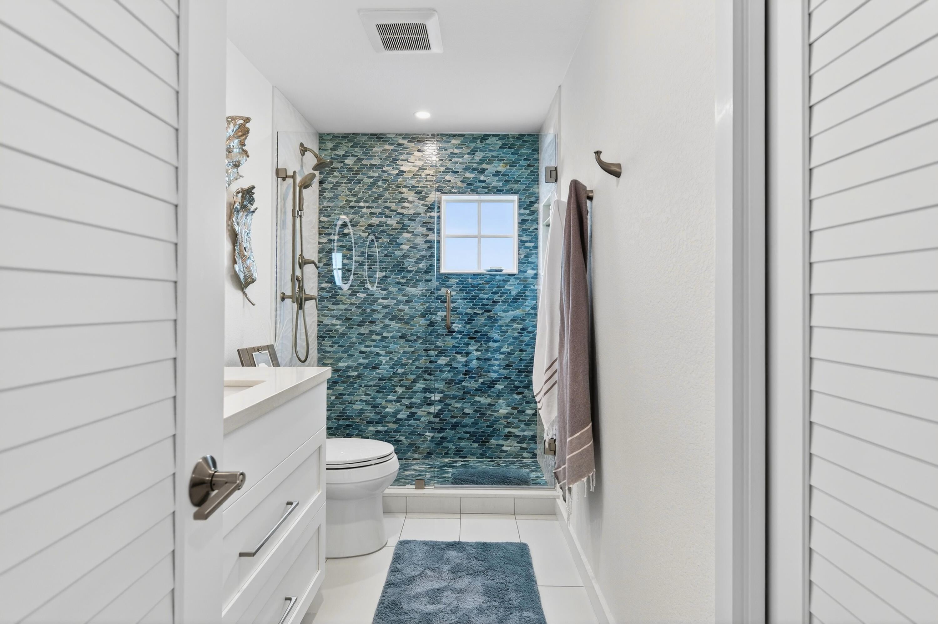5605 College Road, Unit E305 Key West, FL 33040 - Photo 13 of 40 a bathroom with a shower a toilet and a shower
