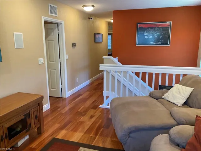 a bedroom with furniture and wooden floor