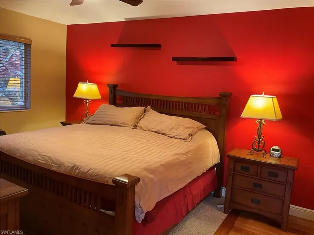 a bedroom with a bed and a lamp