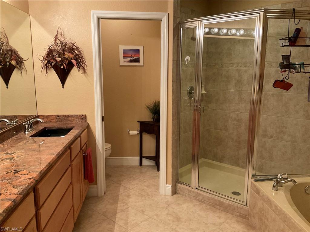 17560 Brickstone Loop Fort Myers, FL 33967 - Photo 17 of 25 a bathroom with a granite countertop sink a toilet and shower