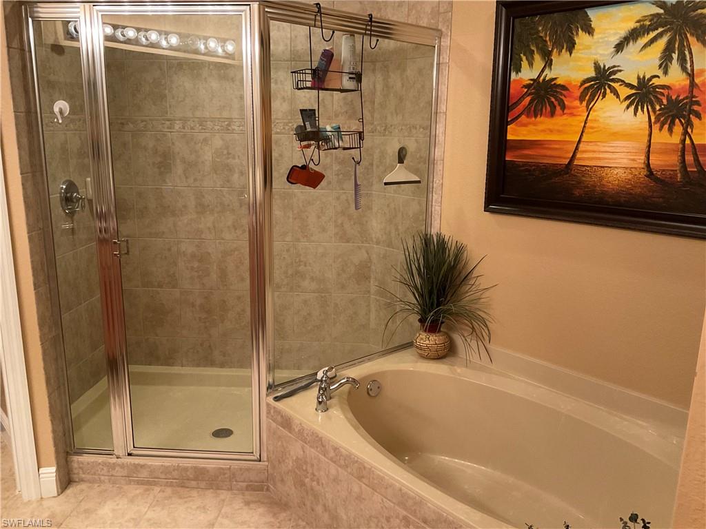 17560 Brickstone Loop Fort Myers, FL 33967 - Photo 18 of 25 a bathroom with a tub and shower