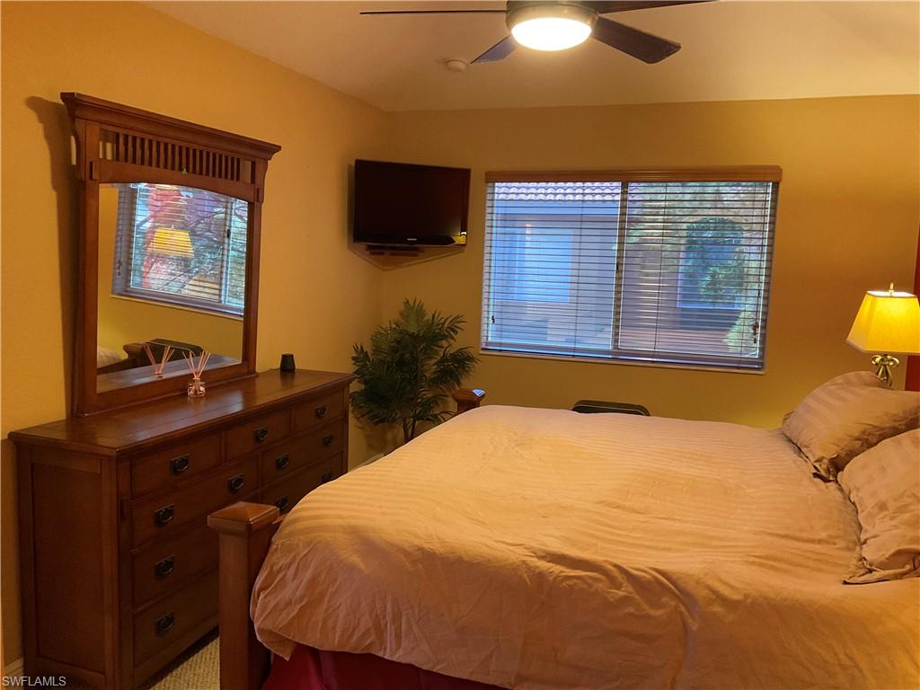 17560 Brickstone Loop Fort Myers, FL 33967 - Photo 21 of 25 a bedroom with a bed and a flat screen tv
