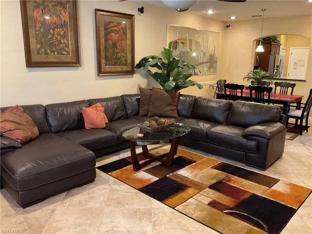 a living room with furniture and a rug
