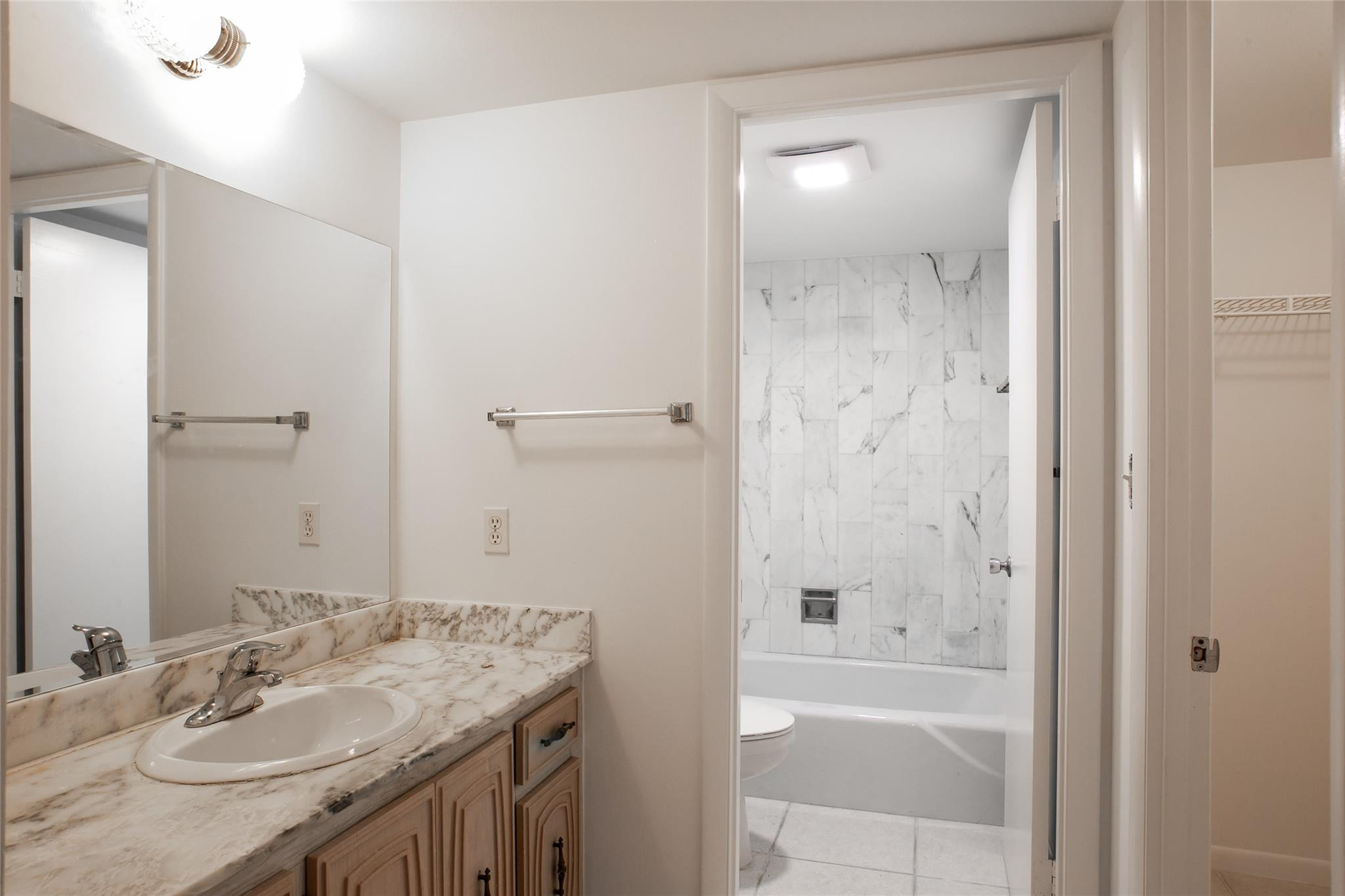 10777 West Sample Road, Unit 718 Coral Springs, FL 33065 - Photo 11 of 16 a bathroom with a granite countertop sink shower and a mirror