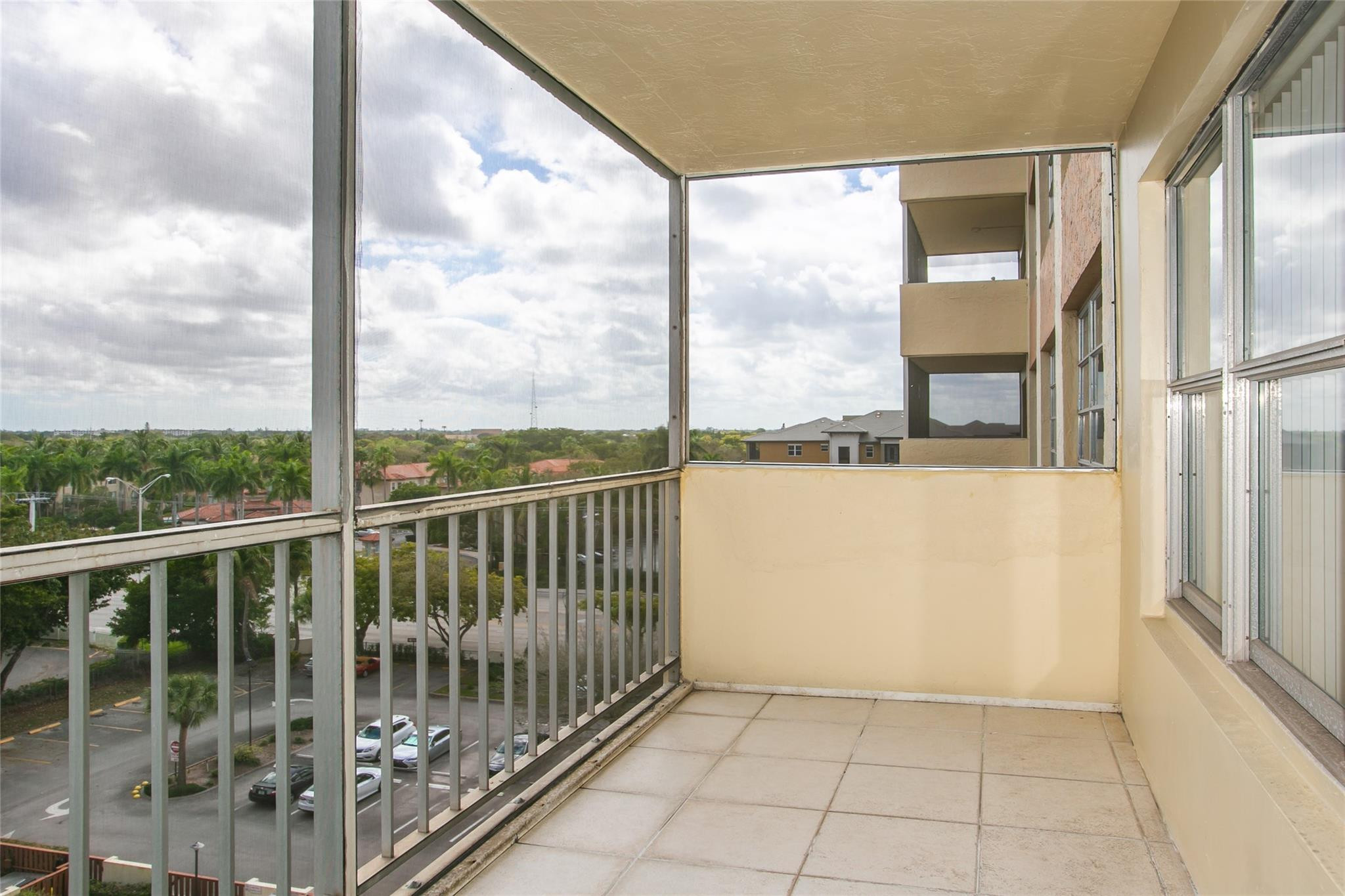 10777 West Sample Road, Unit 718 Coral Springs, FL 33065 - Photo 14 of 16 a view of a balcony with a floor to ceiling window with an outdoor view