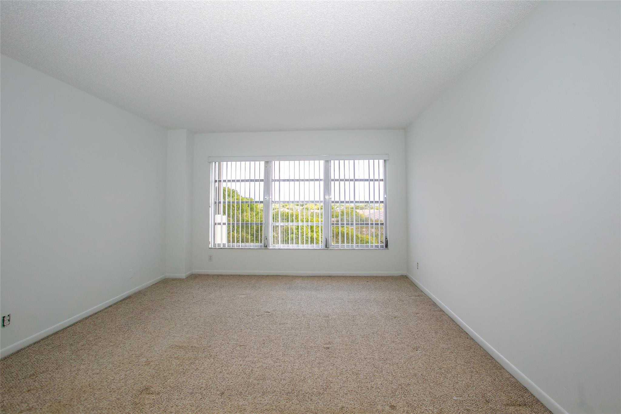 10777 West Sample Road, Unit 718 Coral Springs, FL 33065 - Photo 10 of 16 an empty room with a window