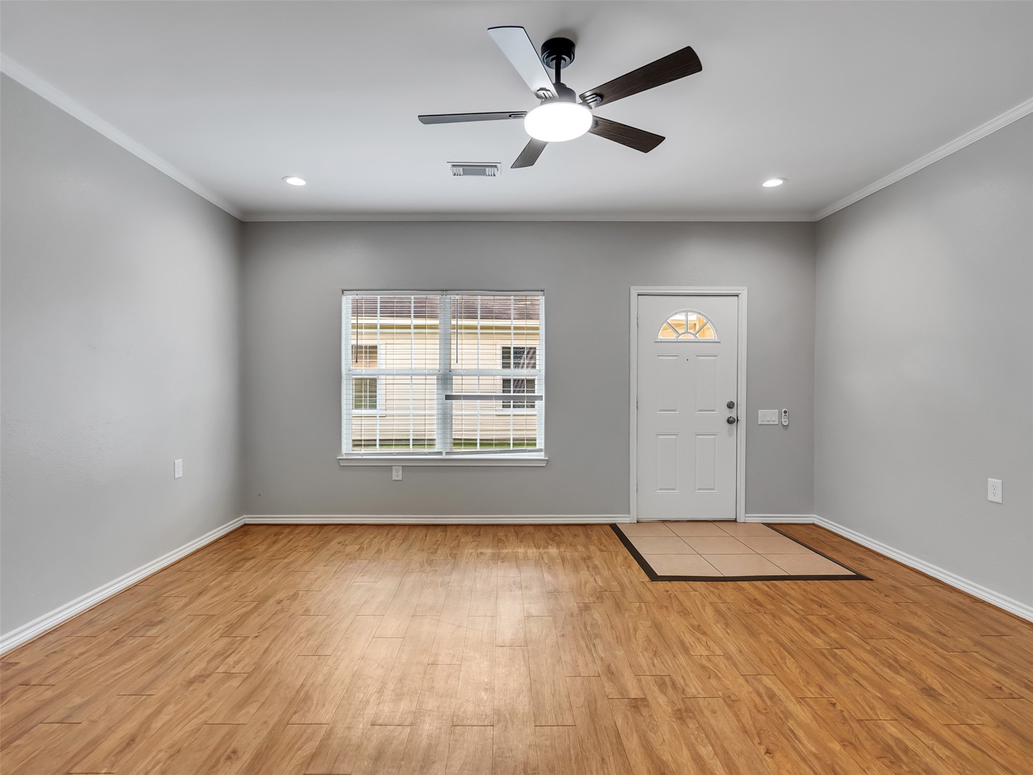 104 Longstreet Road, Unit 2 Willis, TX 77378 - Photo 11 of 26 a view of an empty room with wooden floor and a window