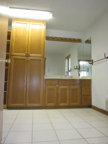 a bathroom with a granite countertop toilet sink and mirror