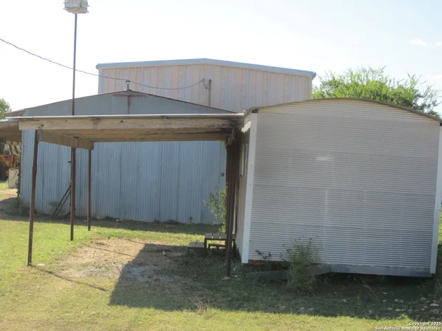 a view of field with trees in the background