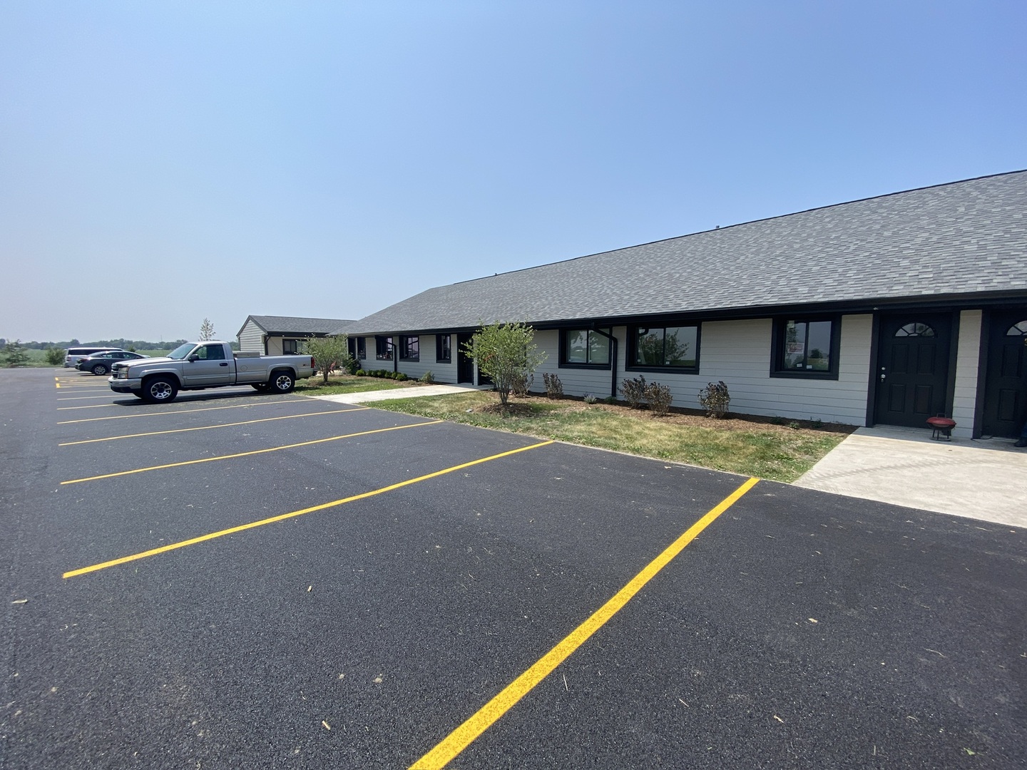 29837 Highway 50, Unit E1 Peotone, IL 60468 - Photo 15 of 17 a view of a building with a swimming pool and sitting area