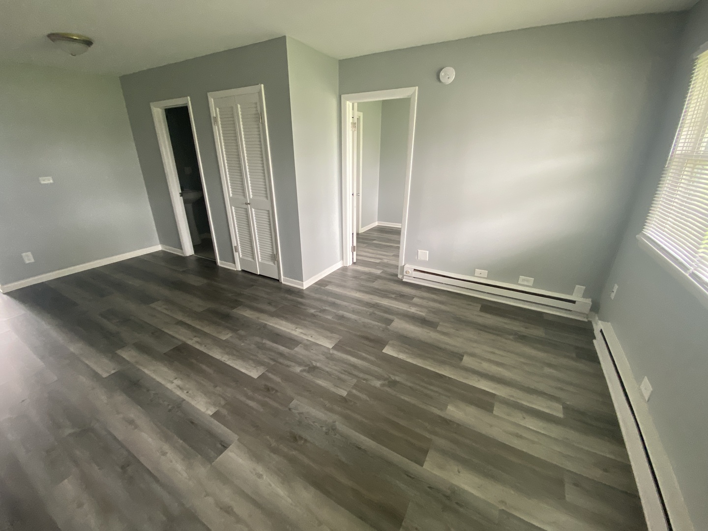 29837 Highway 50, Unit E1 Peotone, IL 60468 - Photo 8 of 17 an empty room with wooden floor and a window