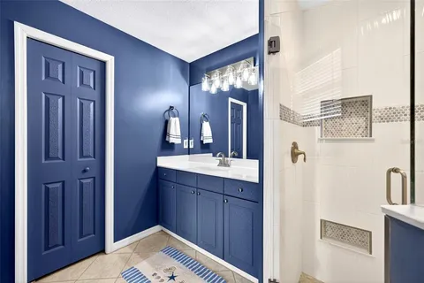 a en suite bathroom with a sink vanity and mirror