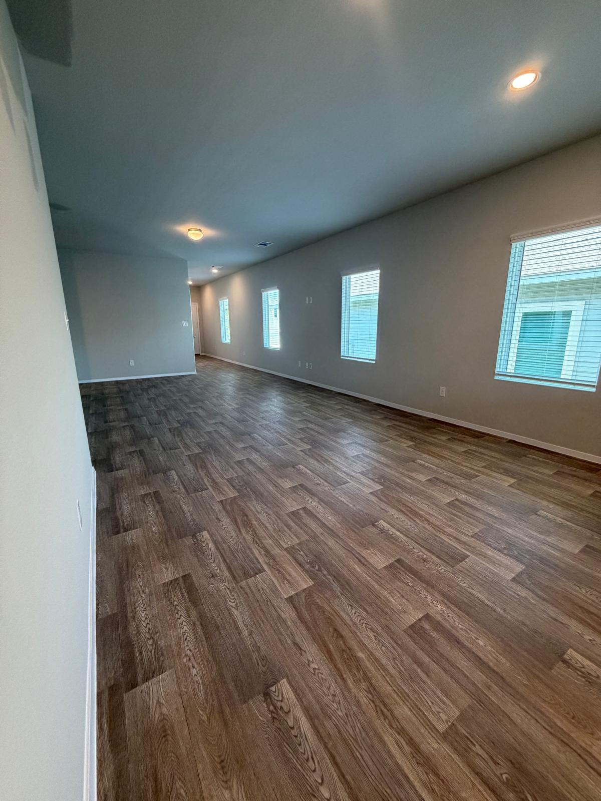 2701 Towy Road Manor, TX 78653 - Photo 11 of 35 Elongated spaces with rich wood-style flooring and recessed lighting.