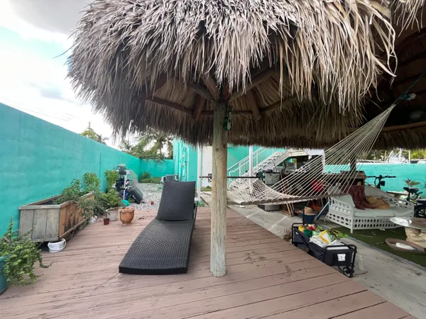 an outdoor sitting area with furniture and garden view