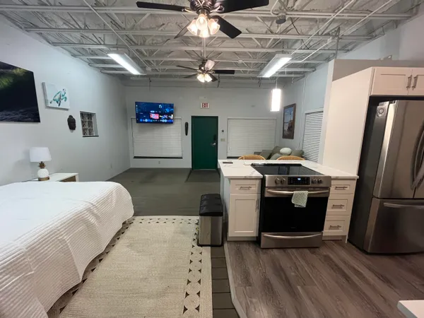 a bedroom with a bed and a television