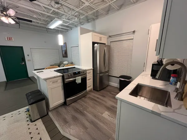 a kitchen that has a sink and a stove top oven