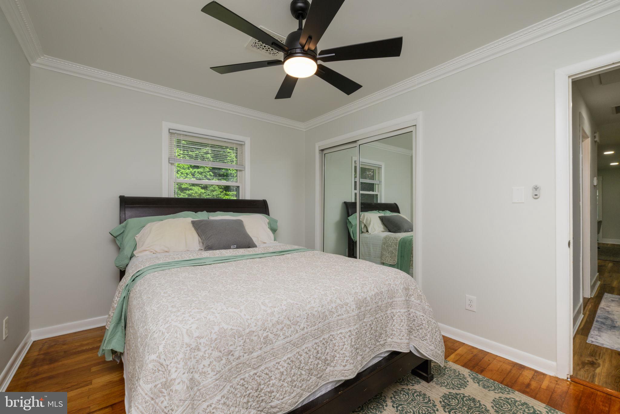 4563 Nutters Cross Road Salisbury, MD 21804 - Photo 51 of 52 a bedroom with a bed and a chandelier