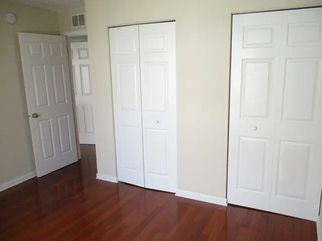 an empty room with wooden floor