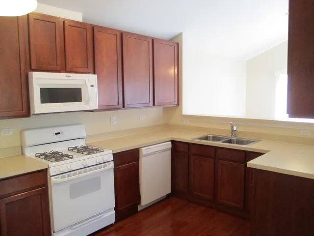a kitchen with stainless steel appliances a stove sink and microwave