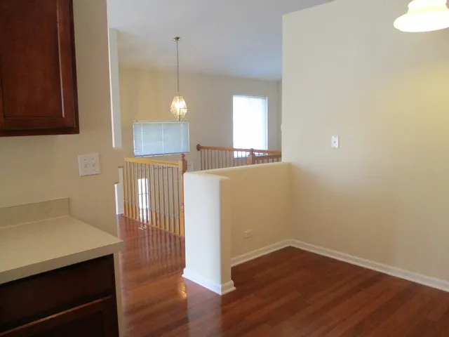 a view of a room with wooden floor and window