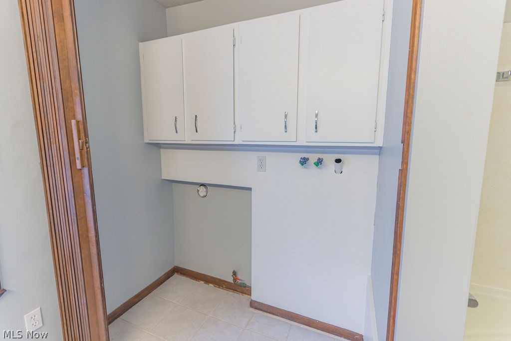51883 Telegraph Road Amherst, OH 44001 - Photo 11 of 49 Laundry area with hookup for a washing machine, cabinets, hookup for a gas dryer, and light tile patterned flooring
