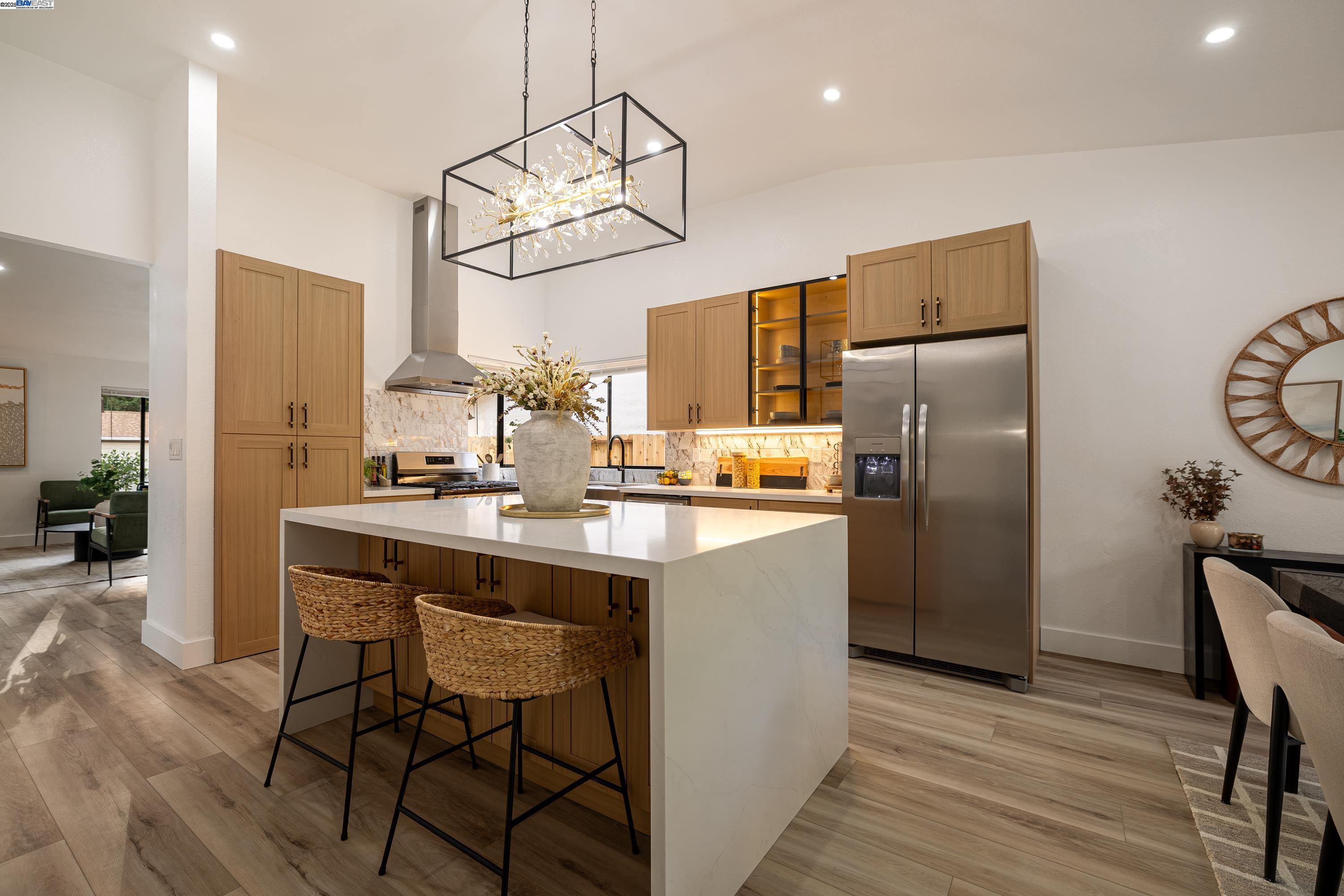 713 Sandy Brook Court Rodeo, CA 94572 - Photo 15 of 36 a kitchen with refrigerator cabinets and wooden floor