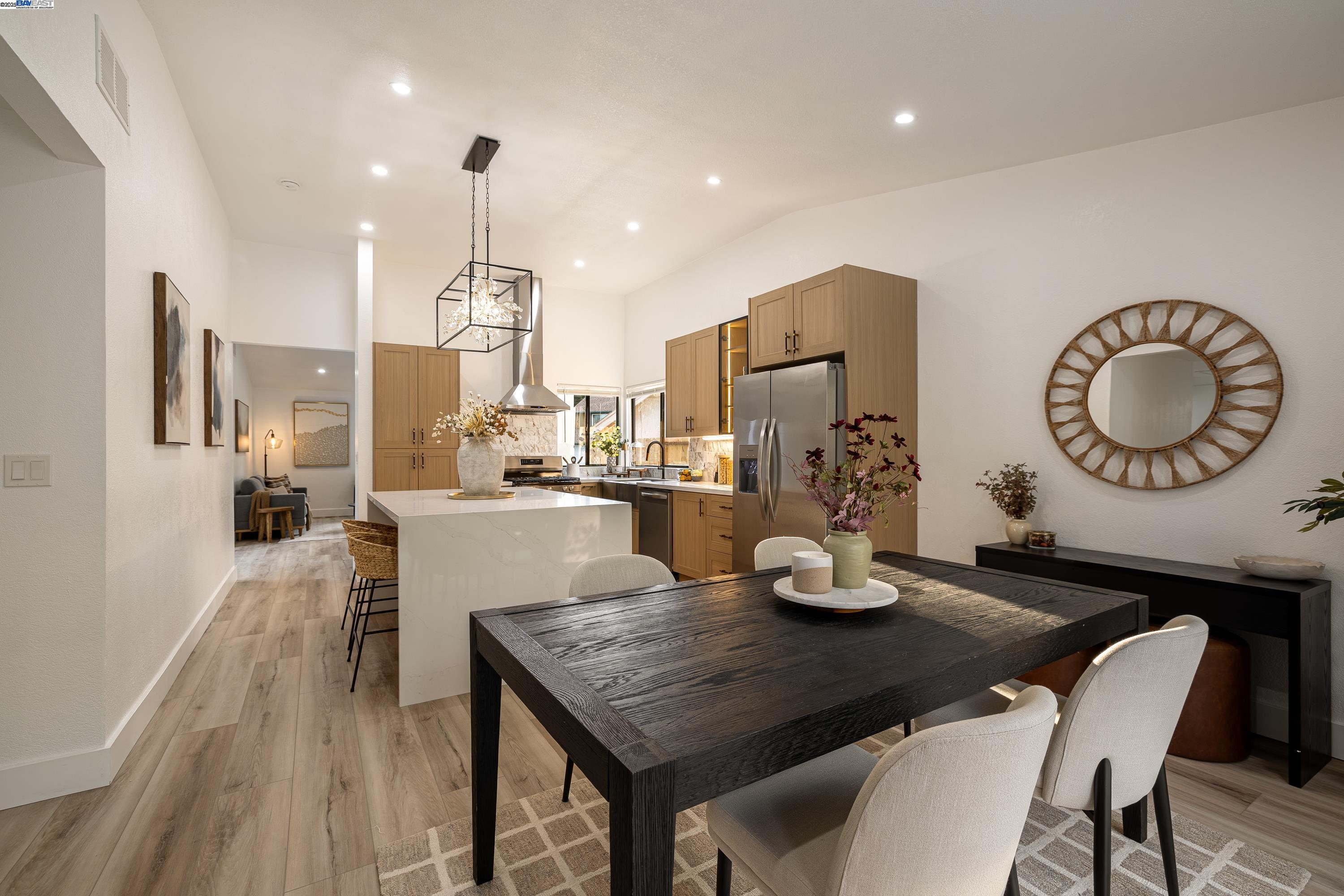 713 Sandy Brook Court Rodeo, CA 94572 - Photo 18 of 36 a kitchen with a table chairs and chandelier