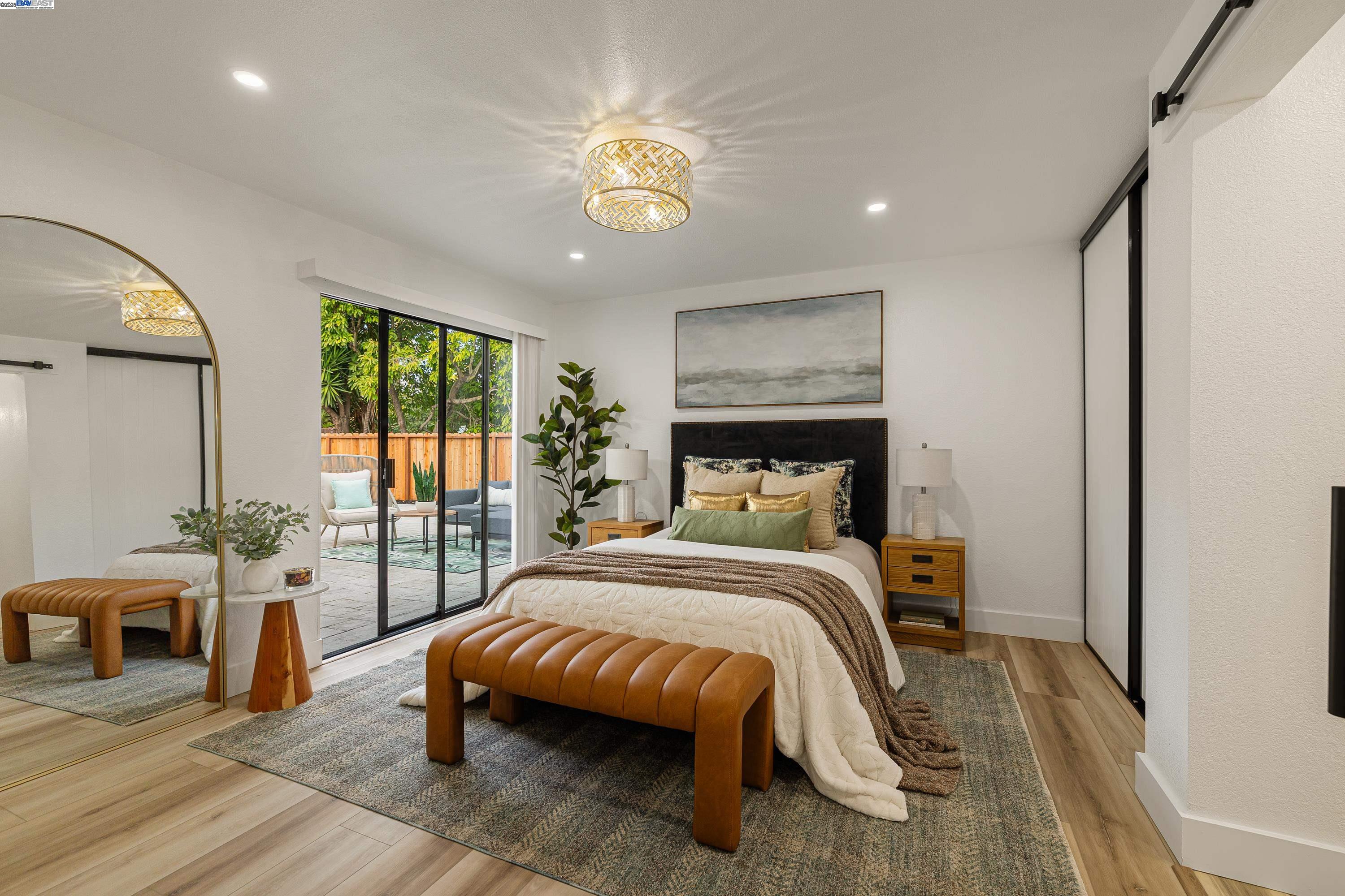 713 Sandy Brook Court Rodeo, CA 94572 - Photo 20 of 36 a bedroom with a bed and a chandelier